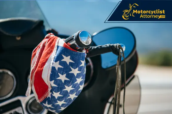 Motorcycle handlebar with an American flag bandana.